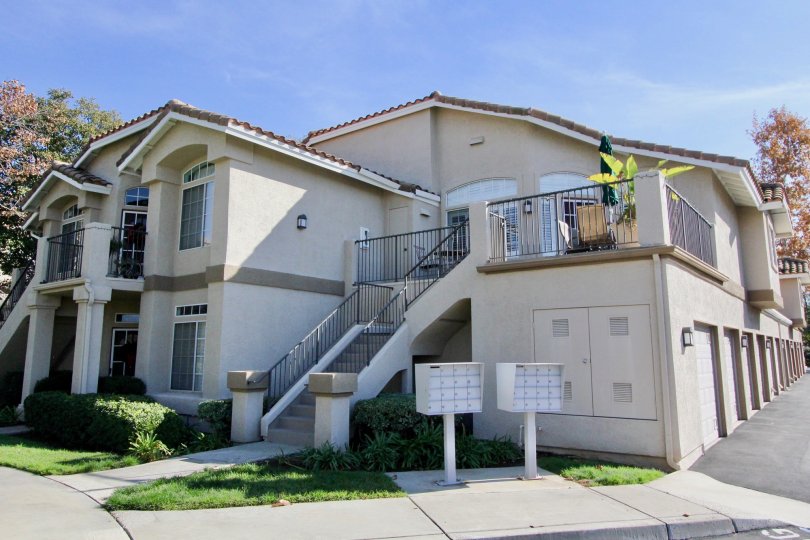 A sunny day in the area of Belflora, outside, condos, door, plants, stairs, windows