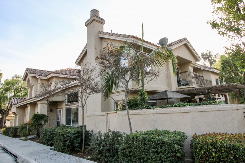 A view from the sidewalk of a home and walled-in patio in Rancho Santa Margarita, CA