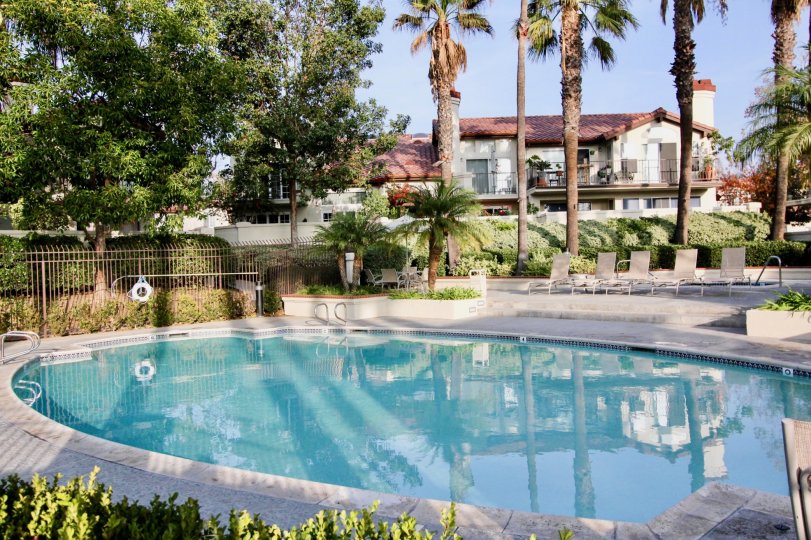 A still pool reflects a residential building in the Candelero community
