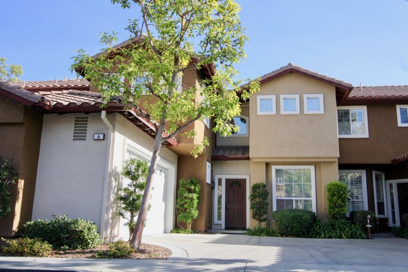 Entry view of two story residences in Sausalito, in Rancho Santa Margarita, California. Residence has attached two car garage.