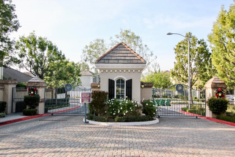 A white flowering bush sits in front of the guard shack at the Sea Country condos