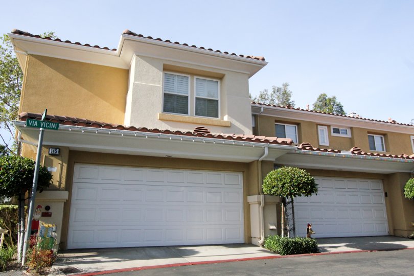 A street view of the two story, two car garage, Spanish style attached residences in the Terracina community