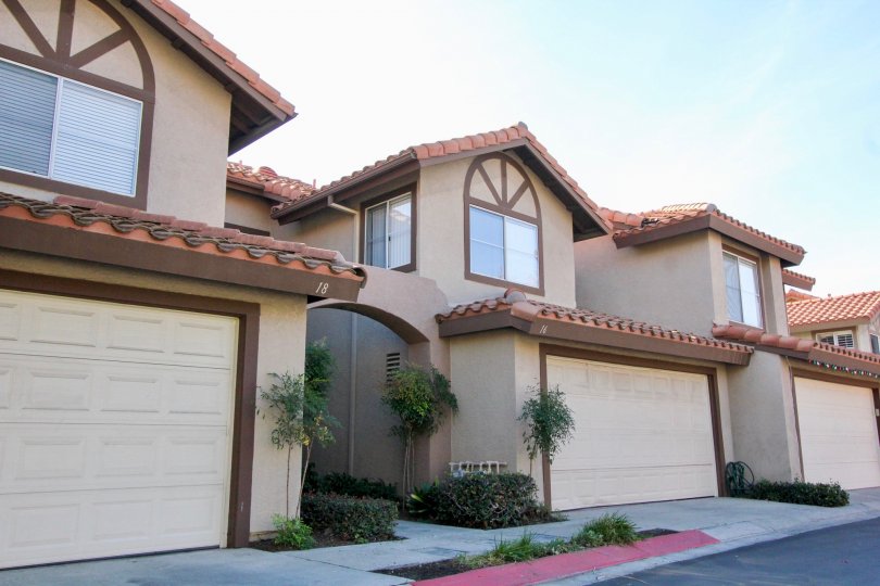 Street view of beige and brown town homes in Vista La Cuesta