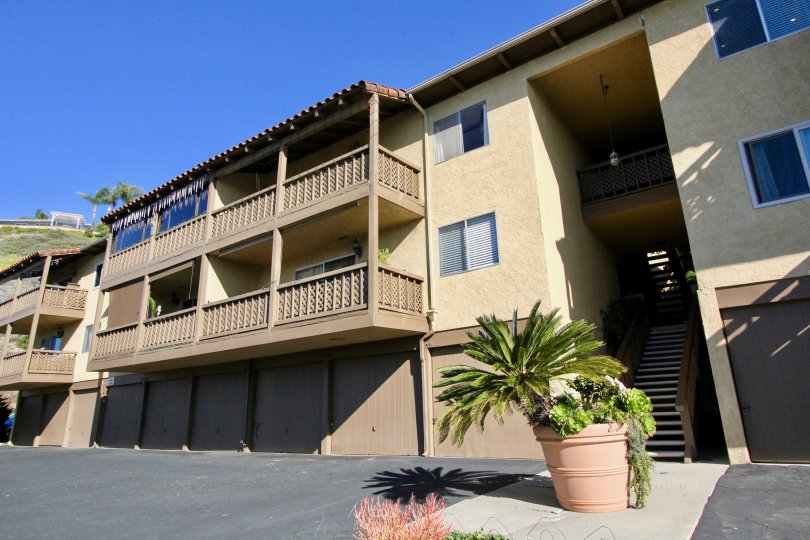 A good Apartment with parrallel houses at the morning time and it has in front of a small plant.
