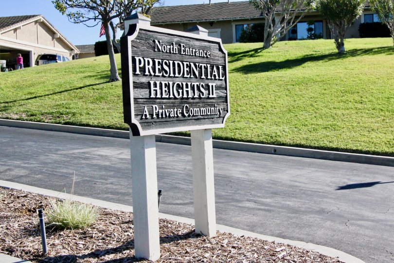 A sign board is placed in the President Heights II nearby the road.