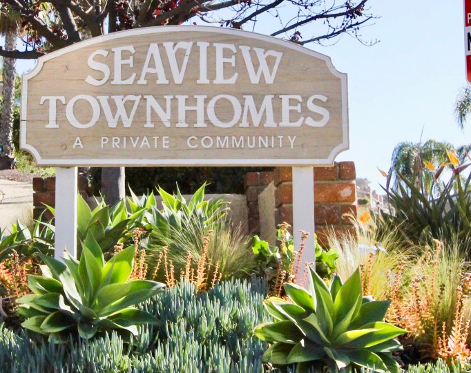 Variety plants with name board of Seaview Townhomes.