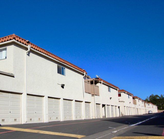 Front view of residences in Tustin Influential Square in Tustin, California. Residences have balconies and garages.