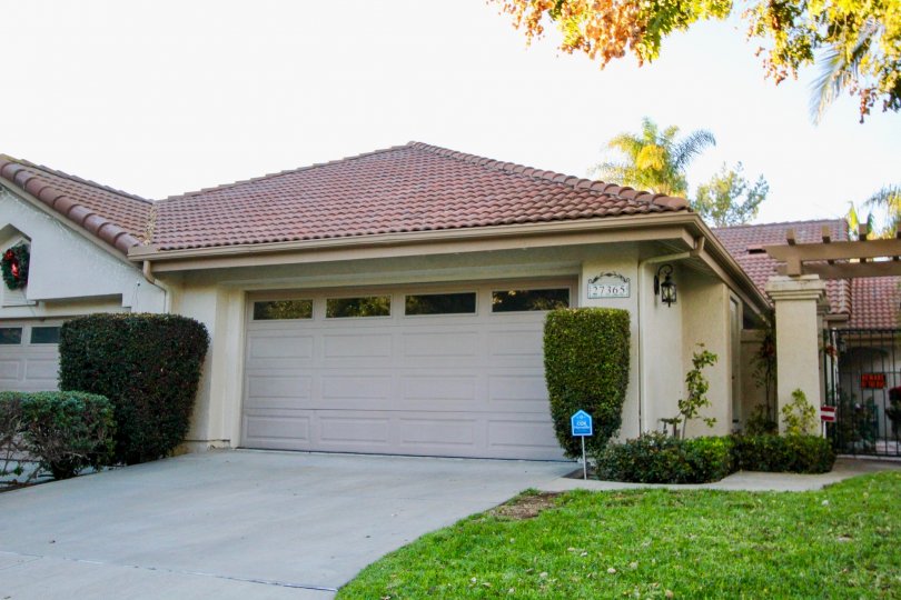 A white home with red roof and garages at Mesa Vista North community in San Juan Capistrano, California.