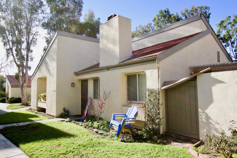 A sunny day in the area of Sun Hollow, condo, outside, trees, fence, window, chair, sidewalk