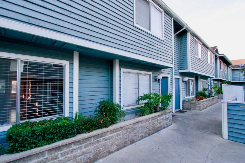 Friendly blue two story townhomes inside the Brightwood Square community in Santa Ana CA