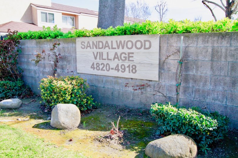 A bright day in the Sandalwood Village with a signage on the wall.