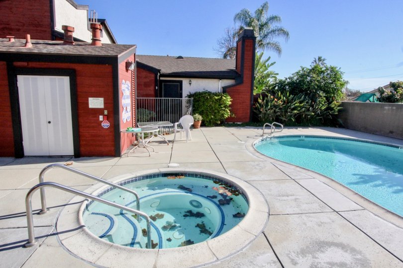 THE RED COLOUR HOUSE INK THE CHAPMAN VILLAS WITH THE SWIMMING POOL, CHAIRS