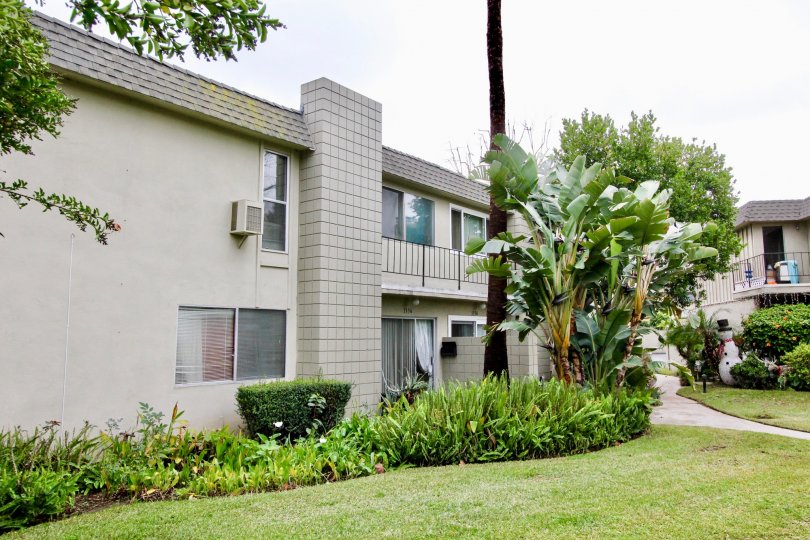 A Beautiful Big House, Small Garden Containing Few Trees, little grass.