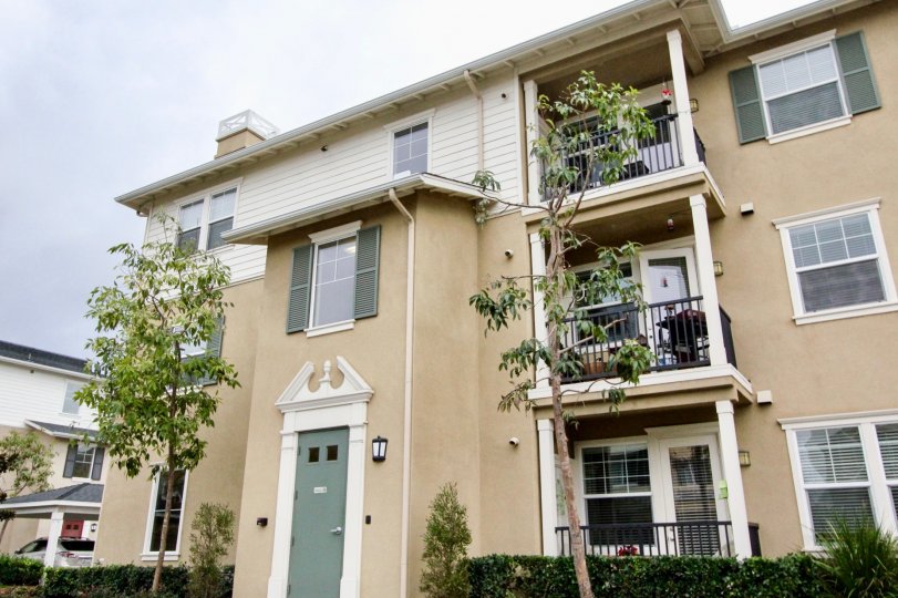 A three-storey townhouse with corner balconies in the Cambridge Lane community.