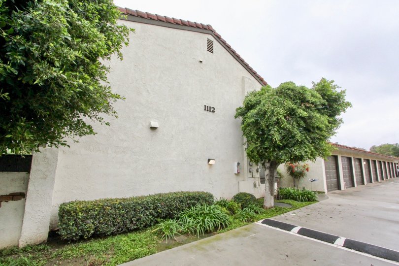 Backlane with speed bump and attached single car garage units for residents of Macaw Cove