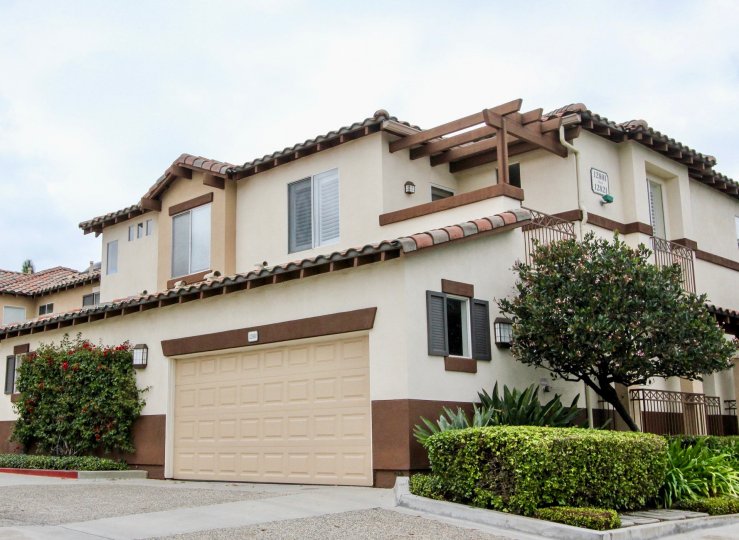 A street level view of the Orchards Community with Spanish tile, landscaping and spacious double garage