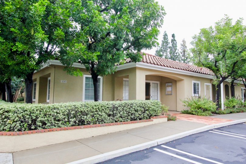 A bungalow with tile roofing in the Shadow Canyon community surrounded by trees.
