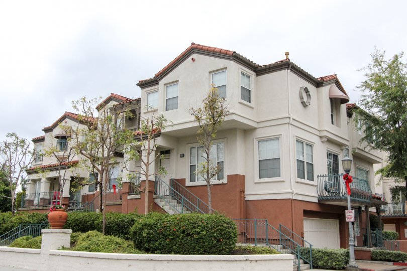A three-storey townhouse painted in dark and light color in the Tustin Del Verde community.