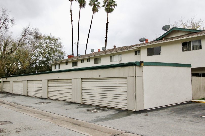 A multiple-car garage with green gutter in the Tustin Place community.