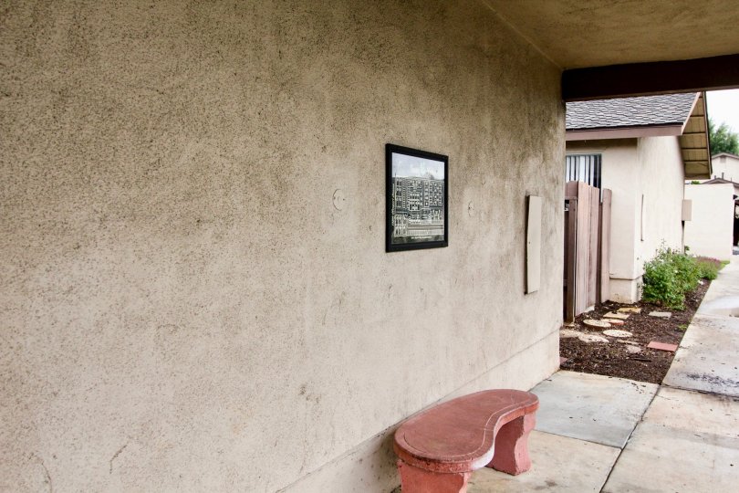 Picture Frame and bench on outside wall of a house in the Tustin Verdes neighborhood.