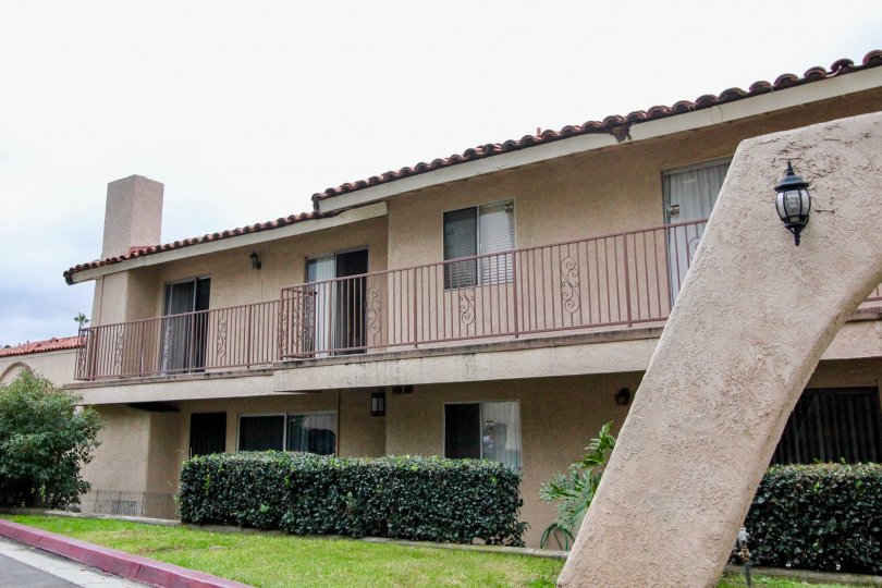 Two-storey apartments with pinkish gates in the Villa Vallerto community.