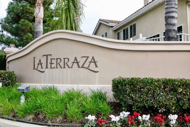 Before to the wall of Laterraza II building has cutting bushes and flowers in plants with trees