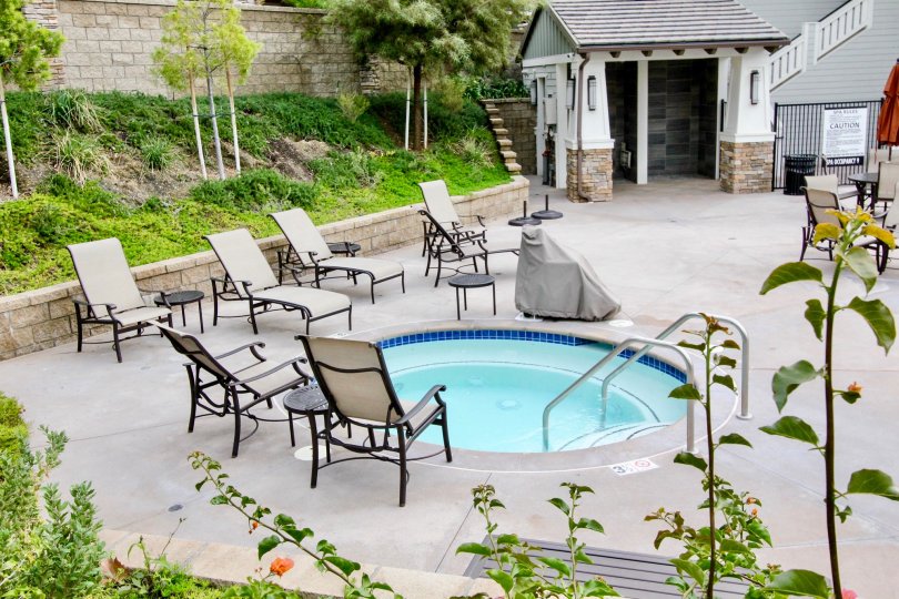 A bright day in the Palisades at Vista Del Verde with a small pool and chairs.