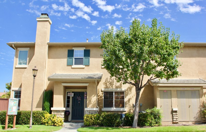 Condo with large trees gardens grounds shutters and chimney