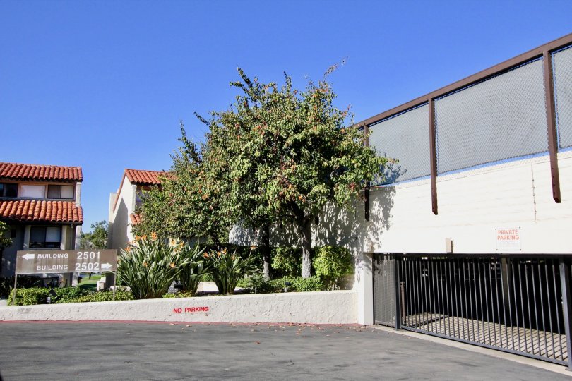 Two homes behind a large parking structure in 2500 Navarra in Carlsbad CA