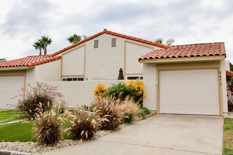 A sunny day in the area of Alta Mira, garage, driveway, palm trees, condos