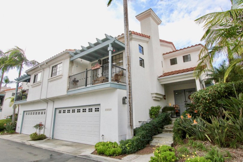 A sunny day in the Bel Azure with large house and garage door.