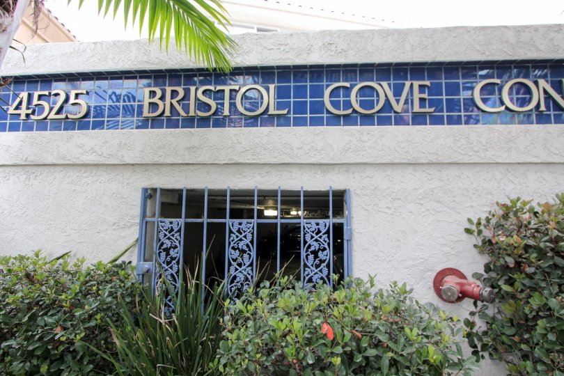 View into a parking lot with bushes in the Bristol Cove Community in Carlsbad, CA.