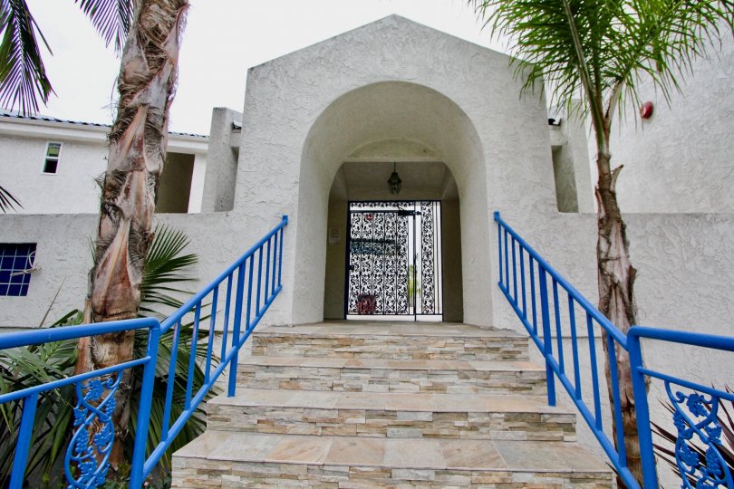 An arched gateway with blue railings in the Bristol Cove neighborhood.