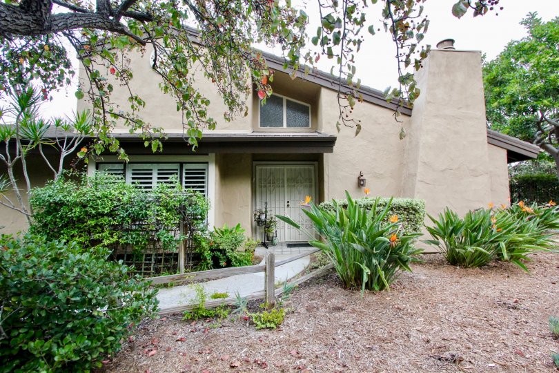 A great day in the Carlsbad Palisades with a house and flowers.