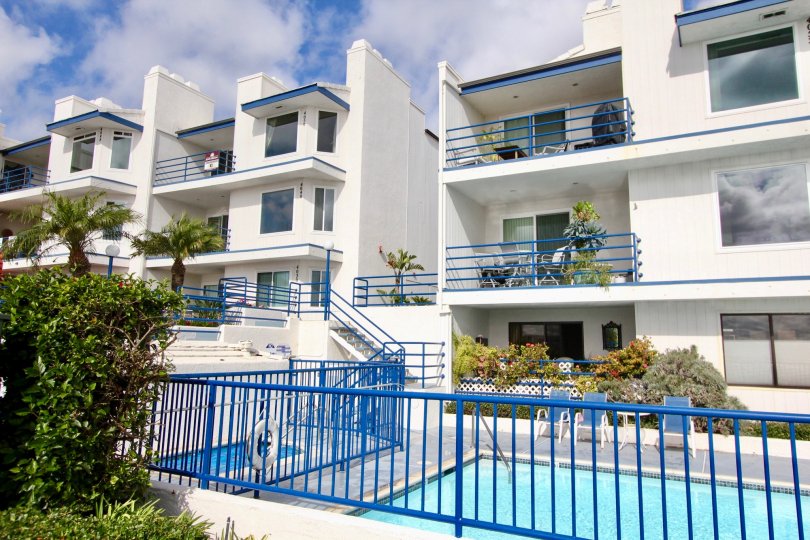 Two buildings with pools on a sunny day in the Llewellyn Shores community.