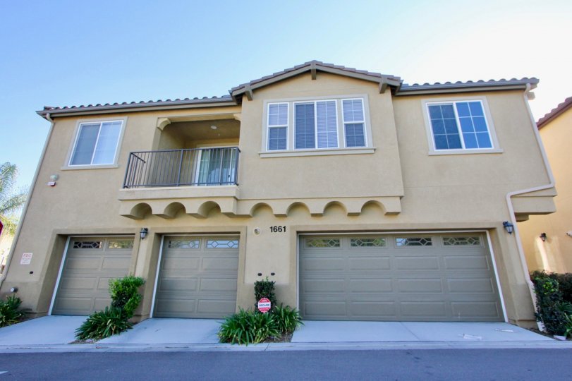 Two small garage doors sit near a long one at Avalon condos