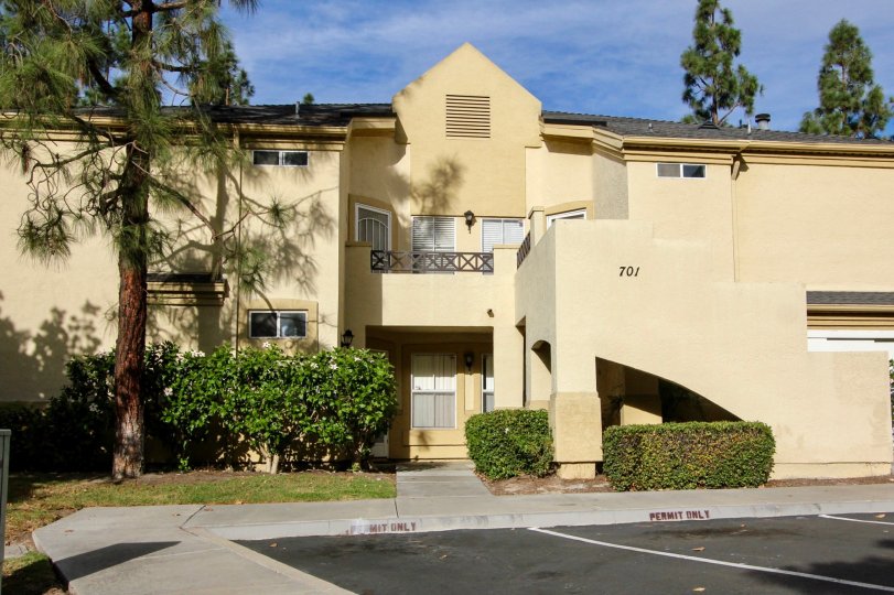 The exterior of 701 Camelot with the balcony and large trees