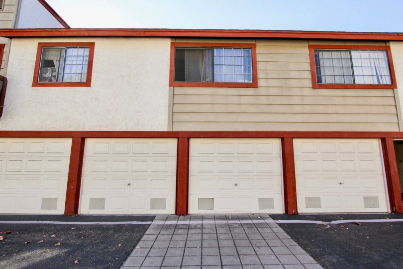 Orange accents on multi-family housing with box fan in window of the leftmost unit: Hilltop Village, Chula Vista, CA