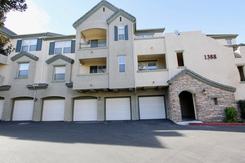 A sunny day in the area of Mer Soleil, outside, driveway, garages, door, balconies, bush