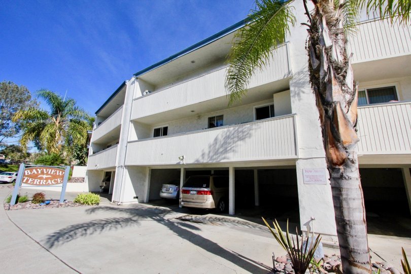 A spacious carprking with trees around in front of a house in Bayview Terrace of Clairemont Mesa