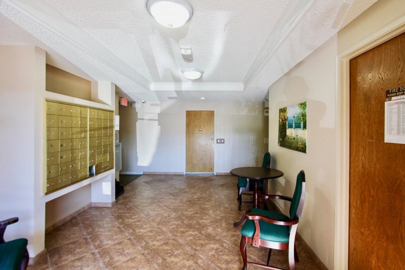 A mailroom with small, golden, key lock boxes in Amherst Spring
