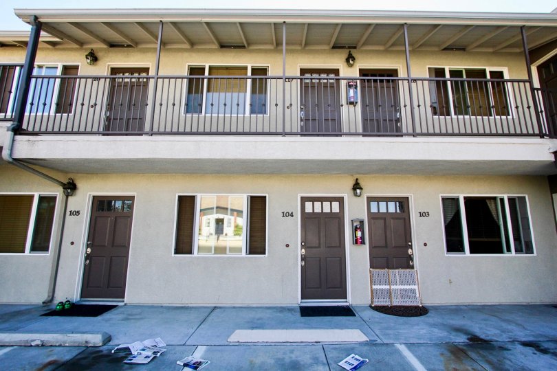 Apartment complex in College area, two level high. Sand colored with dark wood doors.