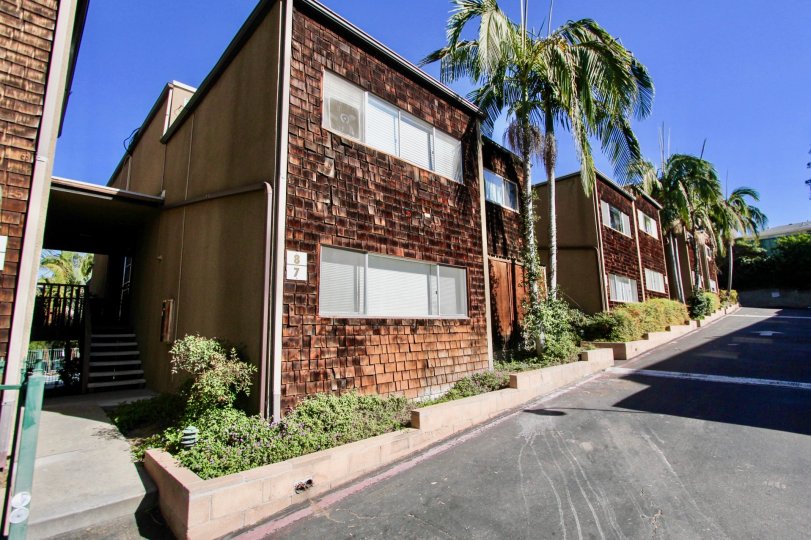 Driveway along side of two story residential buildings at Collwood Townhomes in College Area California