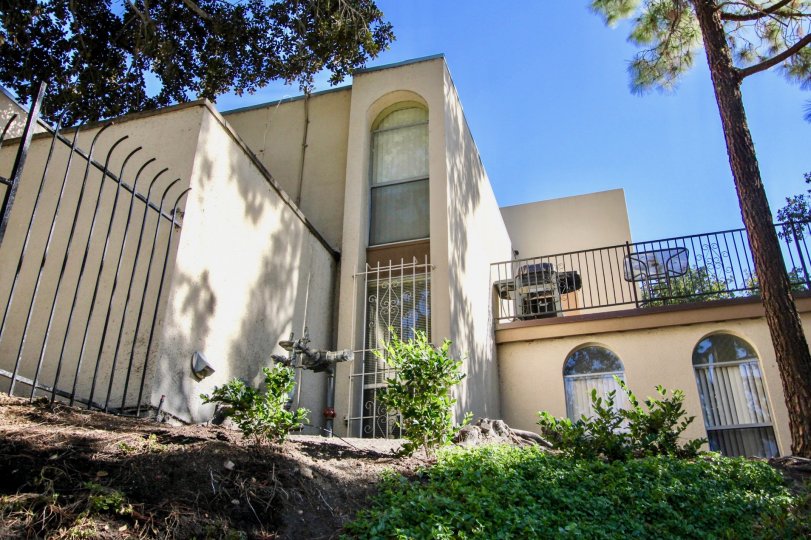 Hillside next to a large white residential building at Collwood Villas in College Area California