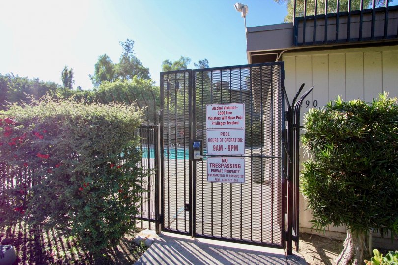 Security gate entrance to pool area at Montezuma Townhomes in College Area California