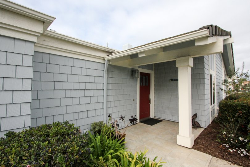 The entrance of a home with a red door and siding in Bahama Village