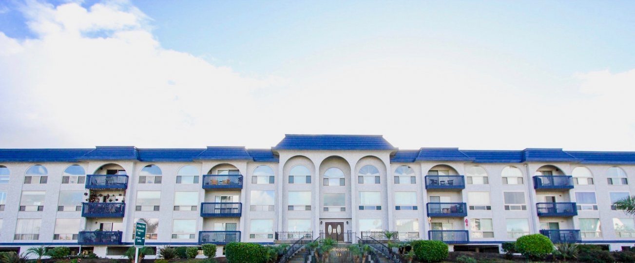 White color building in with blue roof California State in Community of The Commodore in city of Coronado during daytime with blue sky
