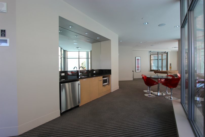 An interior in the Aria with red color chair and wash base.