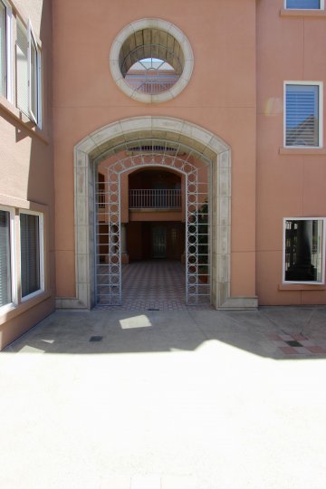 A round glass-less window sits above a stone archway at Columbia Place