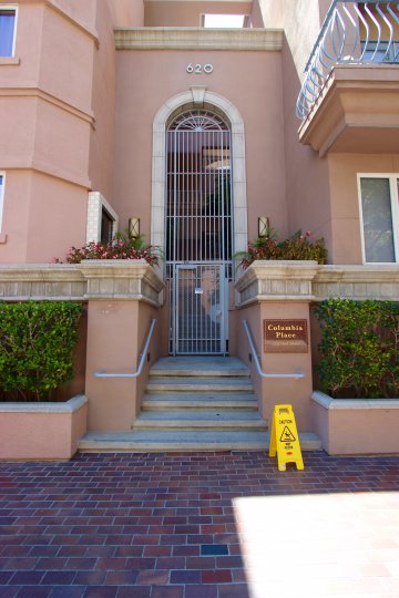 A pink building with a gated front door that would be at home in South Beach